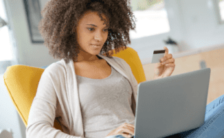 Women looking at laptop and holding a credit card